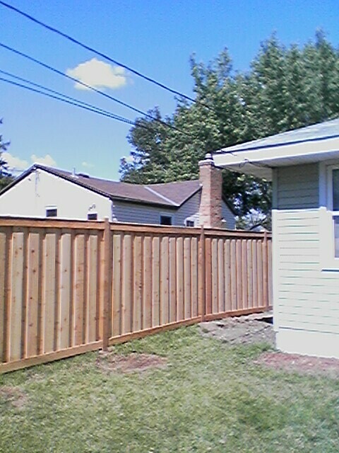 Cedar framed batten board privacy fence installation Minnesota