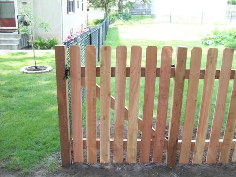 Cedar dog eared picket fence installation Minnesota
