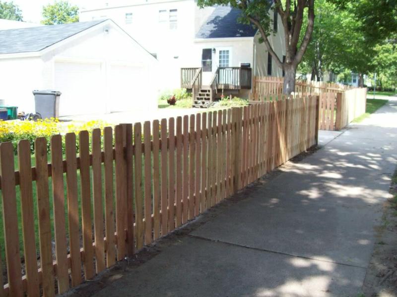 Cedar dog eared picket fence installation Minnesota