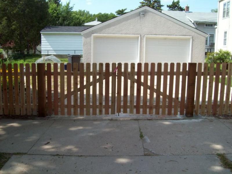 Cedar dog eared picket fence installation Minnesota