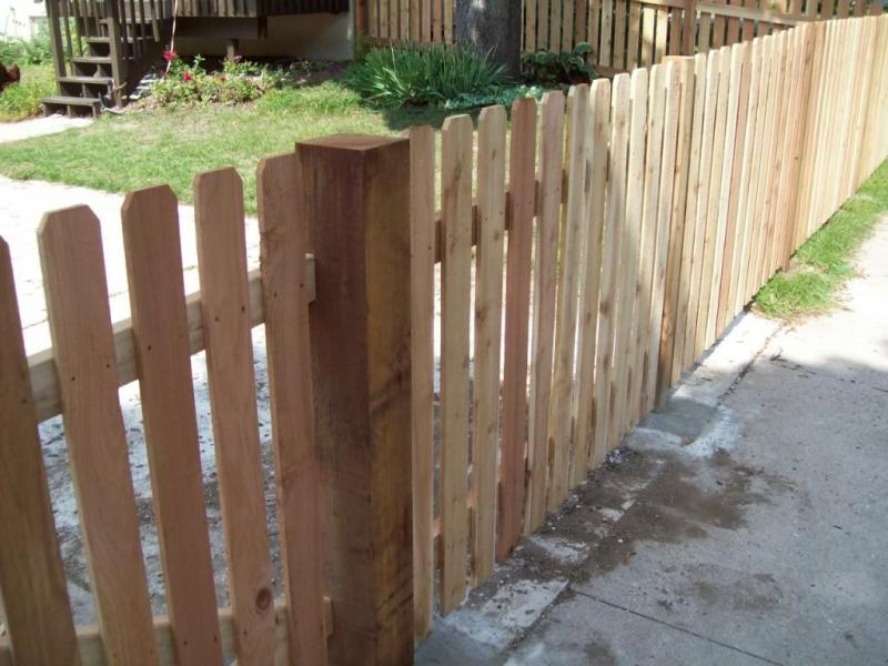 Cedar dog eared picket fence installation Minnesota