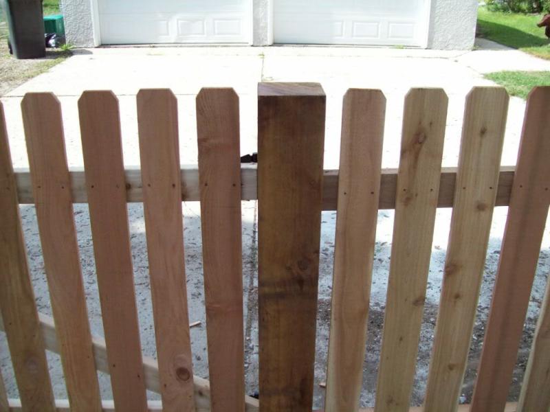 Cedar dog eared picket fence installation Minnesota