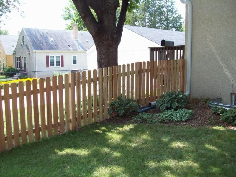 Cedar dog eared picket fence installation Minnesota