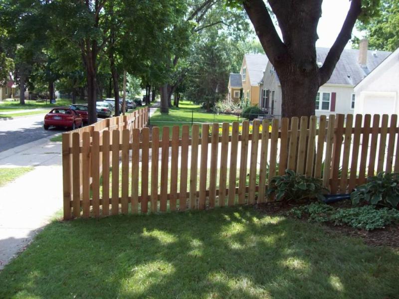 Cedar dog eared picket fence installation Minnesota