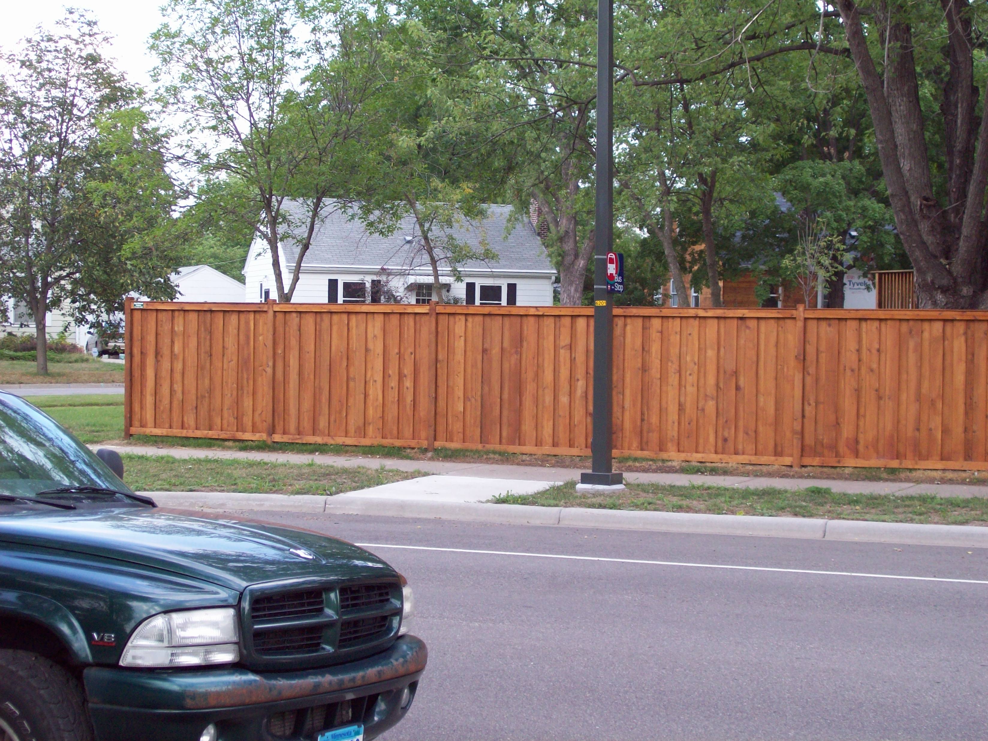 Cedar framed batten board privacy fence installation Minnesota