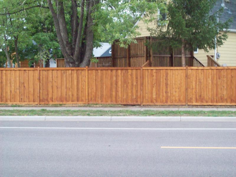 Cedar framed batten board privacy fence installation Minnesota