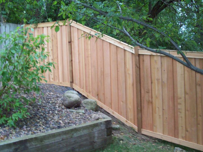 Cedar framed batten board privacy fence installation Minnesota