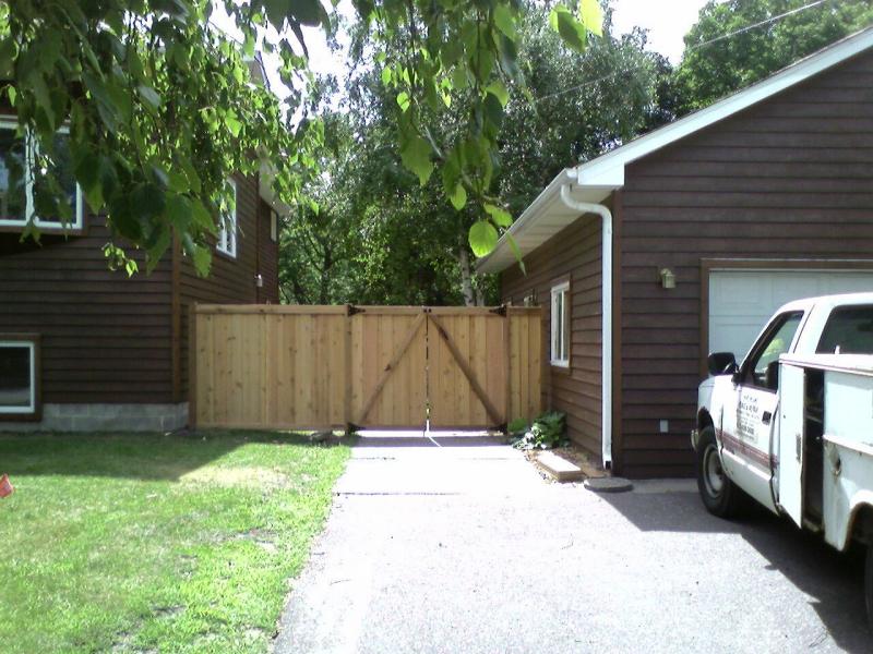 Cedar framed batten board privacy fence installation Minnesota