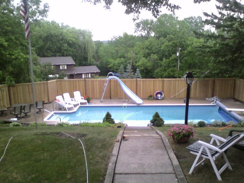 Cedar framed batten board privacy fence installation Minnesota