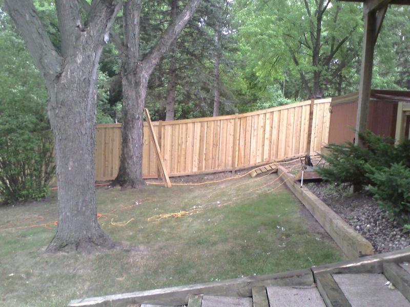 Cedar framed batten board privacy fence installation Minnesota