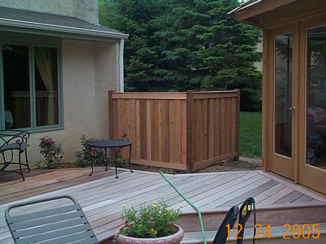 Cedar framed batten board privacy fence installation Minnesota