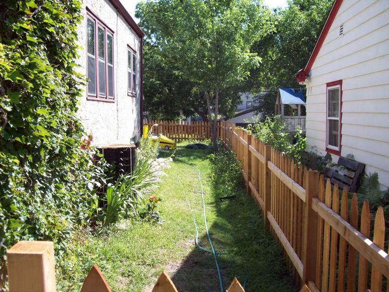 Cedar gothic picket fence installation Minnesota