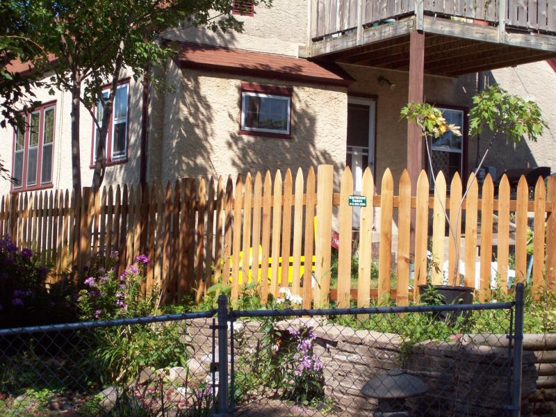 Cedar gothic picket fence installation Minnesota