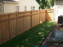 Cedar framed batten board privacy fence installation Minnesota
