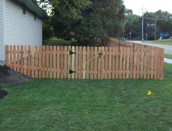 Cedar dog eared picket fence installation Minnesota