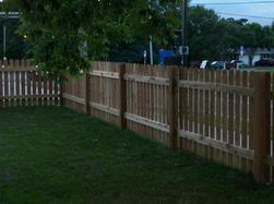 Cedar dog eared picket fence installation Minnesota