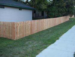 Cedar dog eared picket fence installation Minnesota